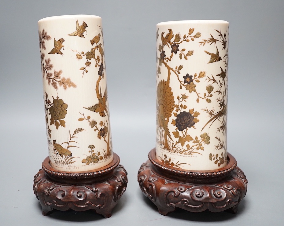 A graduated set of two Japanese gilt lacquered ivory vases, Meiji period, wood stands. Total height 21.5cm